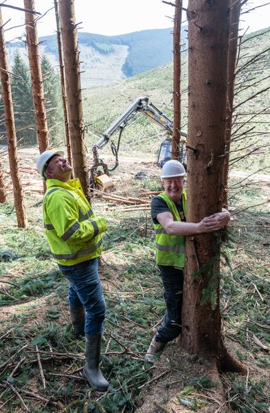 Davy Wilson showing Simon Coleman, Director for large clients at Euroforest, how to hug trees properly.