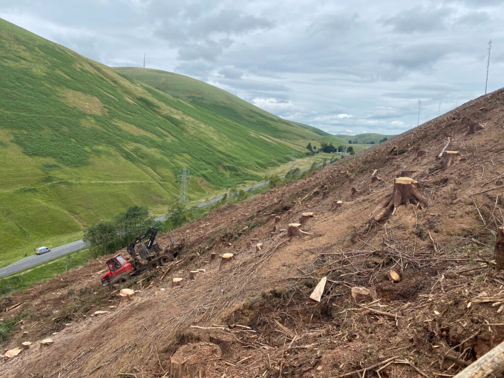 The Komatsu 875 recovering brash on the steep slope in the Scottish Borders.